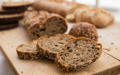 Wall Mural - fresh loaf of bread on wooden board