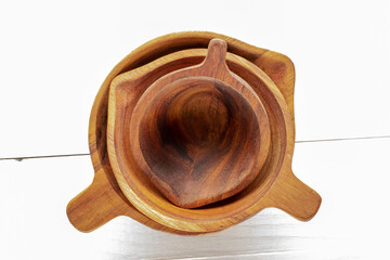 Poster - Three natural wood cups on a wooden table, macro, top view.