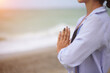 © Svetlana Lavereva - No face portrait of young woman doing yoga or meditating on the seaside. Yoga sport. Healthy wellness lifestyle. Spiritual health. Personal fulfillment.