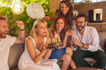 Wall Mural - Girl blowing candles on her birthday cake