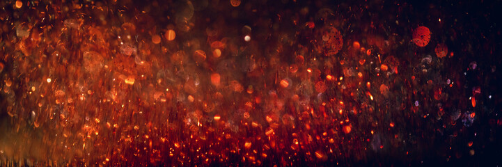 background of abstract glitter lights. orange and black