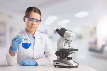 Wall Mural - biotechnologist scientist researching with a microscope in pharma lab. modern laboratory