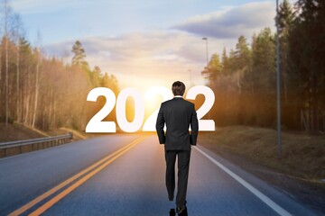 Canvas Print - The 2022 New Year journey and future vision concept. Businessman traveling on highway road