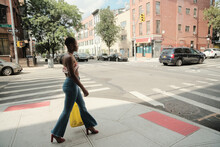 USA, New York City, Stylish Woman Walking On Sidewalk