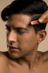 Wall Mural - Studio portrait of man brushing hair