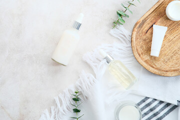 Wall Mural - skincare cosmetics in white bottles and containers with green eucalyptus leaves on stone table. natu