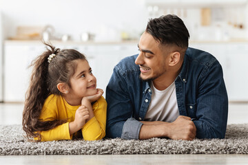 Wall Mural - Happy Middle Eastern Family Dad And Daughter Relaxing Together On Floor