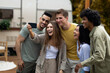 © Prostock-studio - Happy multiracial friends taking selfie near their trailer, smiling and having fun together during autumn camping trip