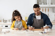 © Prostock-studio - Positive Arab Family Dad And Daughter Baking Cookies In Kitchen Together