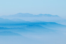 Hills With Rising Fog From The Valleys Below