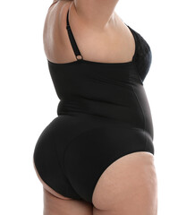 Wall Mural - Overweight woman in black underwear on white background, closeup. Plus-size model