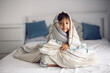 © saulich84 - boy child is sit in bed under striped blanket and does not want to sleep , insomnia and fun