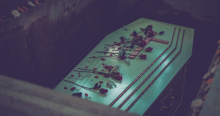 White wooden coffin with Cross and rose flowers