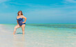 © T.Den_Team - Body positive concept. Middle age lady at the beach in blue swimsuit resting and have a nice time