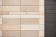 Modern ventilated facade tiles in beige and brown colors on the wall.