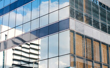 High-rise Buildings Reflected On Another Building Facades
