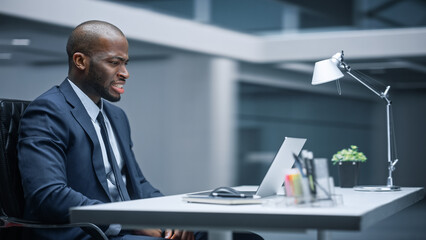 Poster - Modern Office: Businessman Sitting at His Desk Works on Laptop, Loses on Stock Market Emotionally Reacts, Disappointed. Business Entrepreneur in a Suit Suffers Bad Market Crash. Motion Blur Background