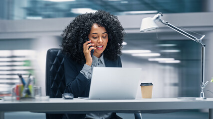 Poster - Modern Office: Productive Businesswoman Sitting at Her Desk Working on a Laptop Computer, Answering the Phone. Woman working with Big Data e-Commerce Analysis. Energetic Shot Motion Blur Background
