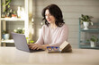 © naumenkoe - Woman 35-40 years old, works in a laptop at home, online work