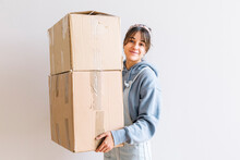 Positive Woman Carrying Carton Boxes