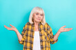 Photo of pretty sad upset mature woman shrug shoulders puzzled thoughtful isolated over teal color background