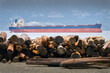 © maxdigi - Logs on Beach after Storm. Logs stacked on a Vancouver beach after king tides and a winter storm brought them ashore.