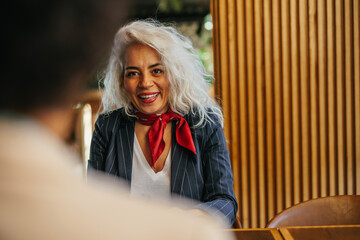 Smiling middle age woman at cafe with friend