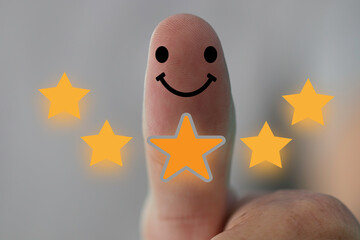 Customer satisfaction concept, 5-star satisfaction rating thumbs-up, and positive-emotional smiley faces showing excellent satisfaction. The concept of customer satisfaction improves 