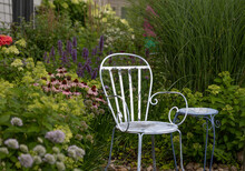 A Blue Antique Metal Chair Is The Focal Point Of This New Prairie Garden Featuring, Pink Cone Flowers, Blue Boa Agastache, Little Lime Hydrangea And A Tall Miscanthus. 