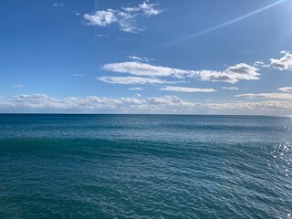perfect line of the sea horizon, deep blue sea surface and blue sky
