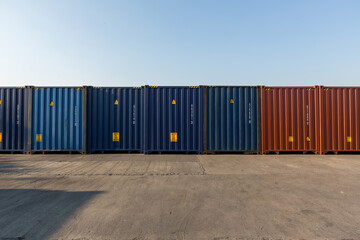 Wall Mural - Stack of containers in a harbor. Shipping containers stacked on cargo ship. Background of Stack of Containers at a Port.