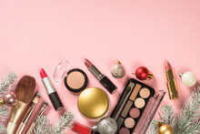 Make Up Cosmetic Products And Christmas Decorations At Pink. Flat Lay Image With Copy Space.