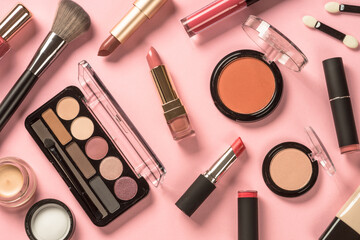 Poster - Make up products at pink background. Eye shadow, lipstick, powder, cream, brushes and more for professional make up. Flat lay image.