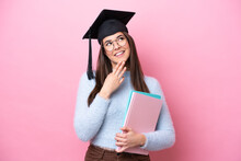 Young Student Brazilian Woman Wearing Graduated Hat Isolated On Pink Background Looking Up While Smiling