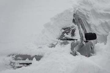 car covered with snow after a heavy snow storm.Vehicles are covered with snow during a heavy snowfall.