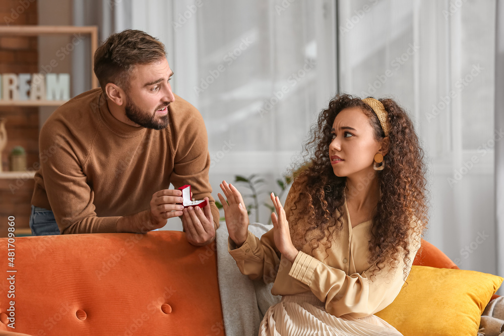 Young woman rejecting marriage proposal at home