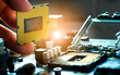 © Photo Sesaon - Hand of computer engineering brings computer CPU processor memory change components into socket processor for maintenance.Technology and development concept