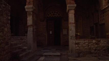 Wall Mural - Entering the dark entrance to an ancient greek chapel