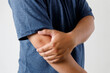  close up man guy holding touching painful elbow  Pain relief concept