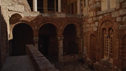 Wall Mural - Passing the entrance to an ancíent greek chapel in golden sunlight