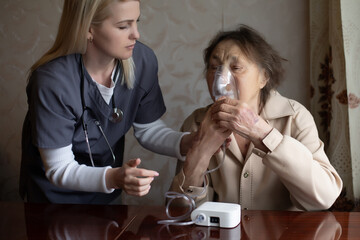 Wall Mural - Young Female Doctor Holding Oxygen Mask Over Senior woman Patient's Face