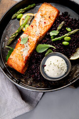 Wall Mural - Baked salmon with asparagus and black rice.