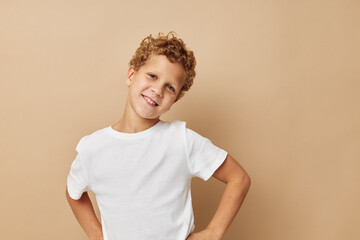 Wall Mural - Cute little boy in a white t-shirt posing fun Lifestyle unaltered