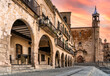view of the arches and church from the main square of Trujillo, Extremadura, Spain - sunset sky.