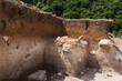 Archaeologists dug a hole on hillside to search for historical artifacts. Archaeological work