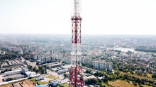 Flying Around The TV Tower Against The Backdrop Of A Big City On A Sunny Day