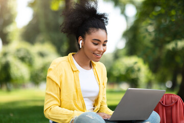 Wall Mural - Black Student Girl Talking To Laptop Webcam During Webinar Outdoor