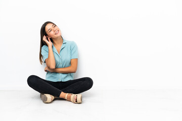 Wall Mural - Teenager girl sitting on the floor thinking an idea