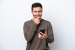 © luismolinero - Young Brazilian man isolated on white background thinking and sending a message