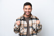 © luismolinero - Young Brazilian man isolated on white background celebrating a victory in winner position